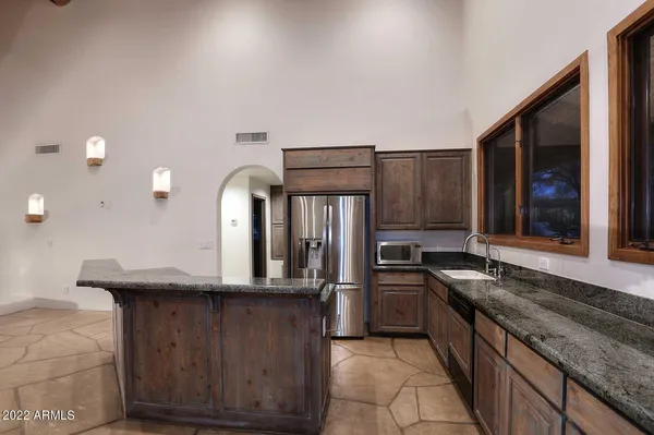 a kitchen with stainless steel appliances granite countertop a stove and a refrigerator