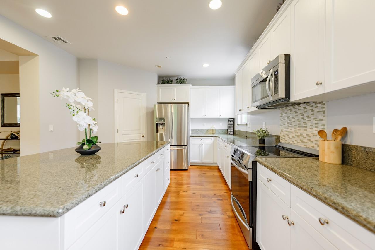 237 Bluebonnet Lane, Unit 304 Scotts Valley, CA 95066 - Photo 20 of 79 a large kitchen with stainless steel appliances granite countertop a lot of counter space and wooden floor