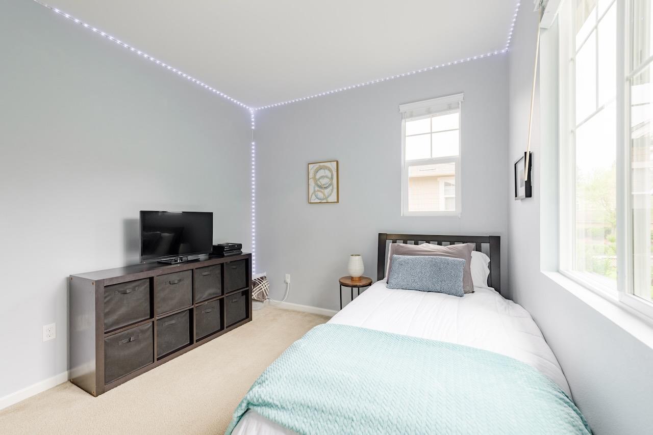 237 Bluebonnet Lane, Unit 304 Scotts Valley, CA 95066 - Photo 47 of 79 a bedroom with a bed and a flat tv screen on a dresser