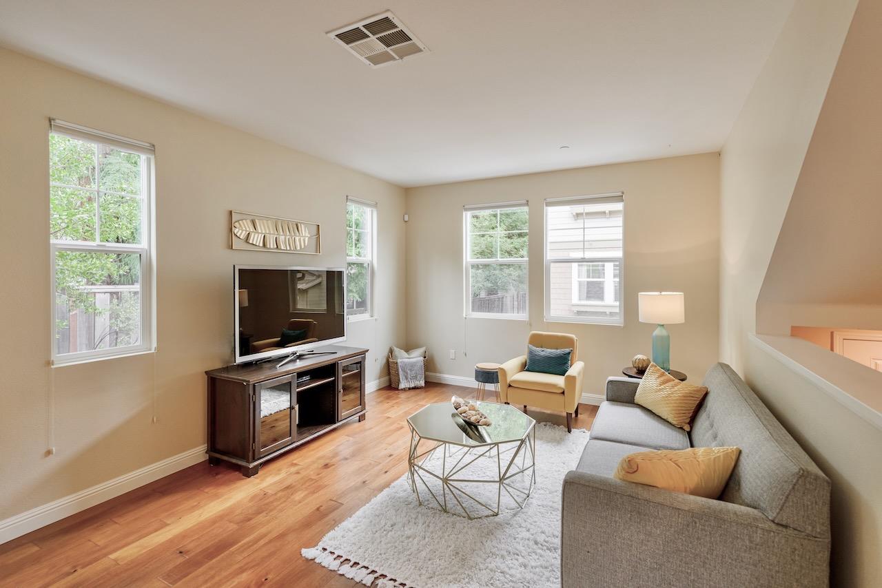 237 Bluebonnet Lane, Unit 304 Scotts Valley, CA 95066 - Photo 10 of 79 a living room with furniture a flat screen tv and a fireplace
