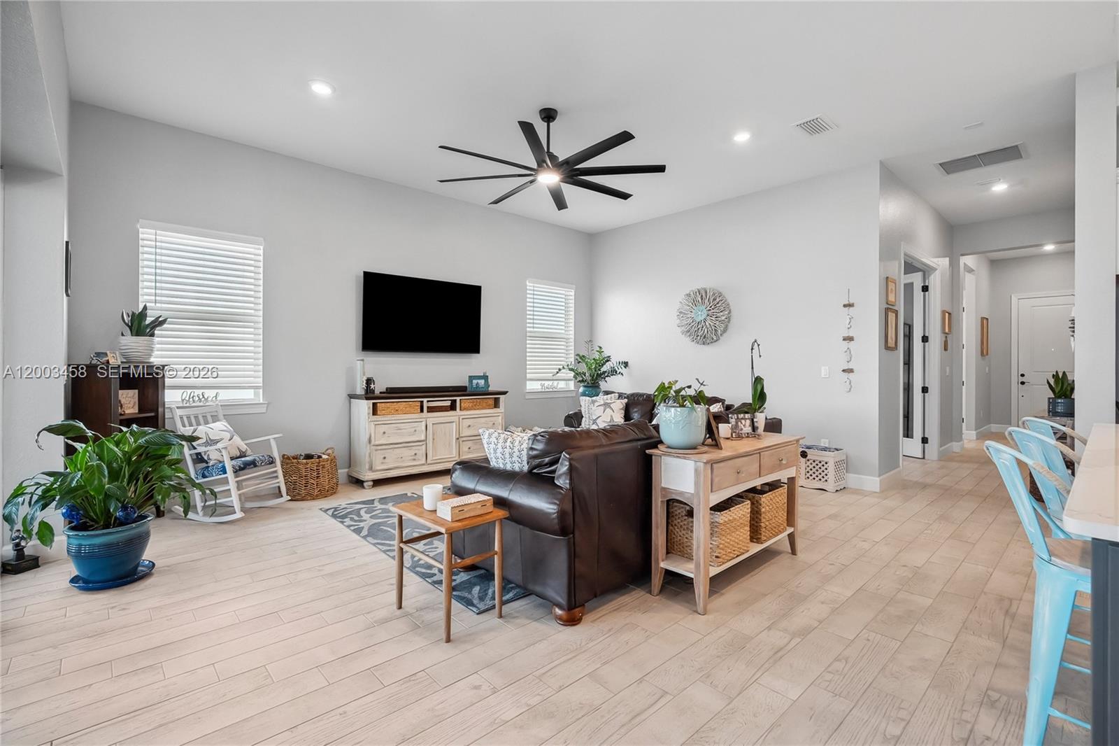 9734 Southwest Meridian Way Stuart, FL 34997 - Photo 14 of 48 a living room with furniture and a flat screen tv
