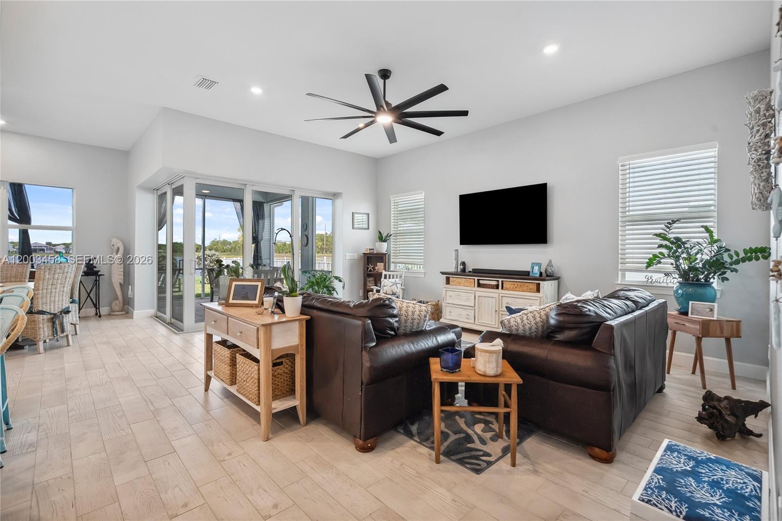 9734 Southwest Meridian Way Stuart, FL 34997 - Photo 17 of 48 a living room with furniture and a flat screen tv