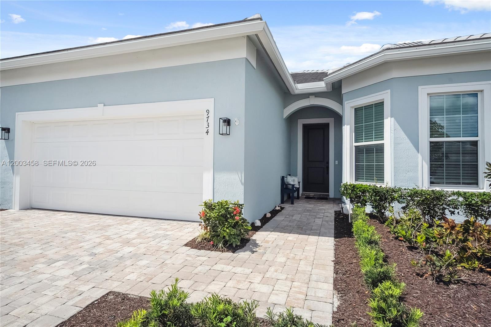 9734 Southwest Meridian Way Stuart, FL 34997 - Photo 4 of 48 a front view of a house with garden