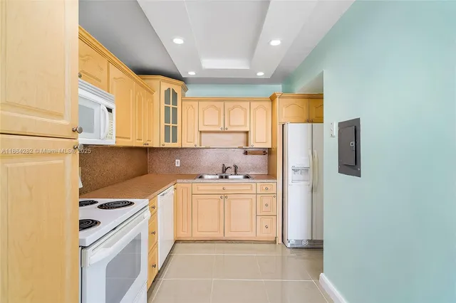 a kitchen with stainless steel appliances a refrigerator sink and cabinets