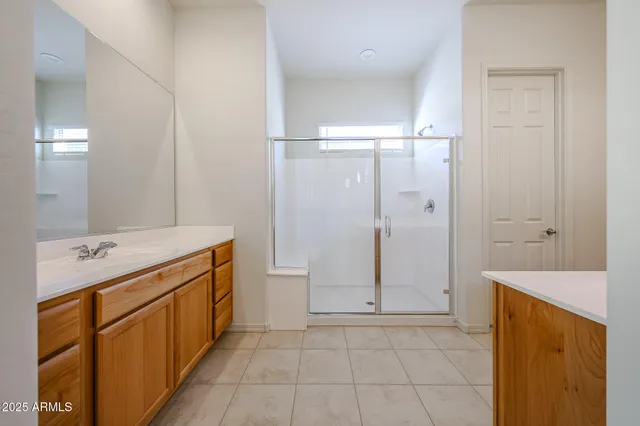 a bathroom with a glass shower door