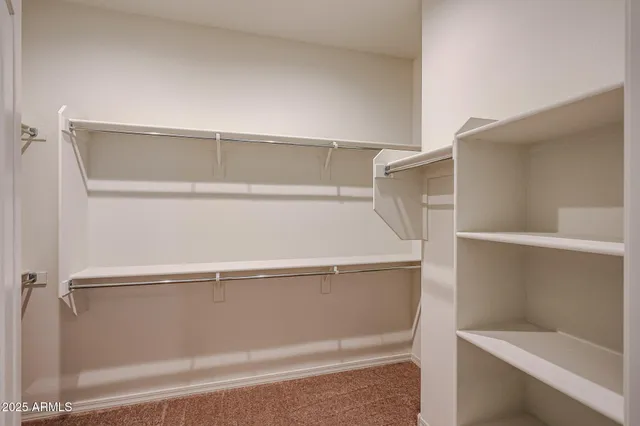 a view of a livingroom with a chandelier fan