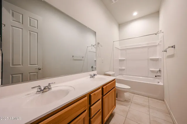 a view of an empty room with a chandelier fan