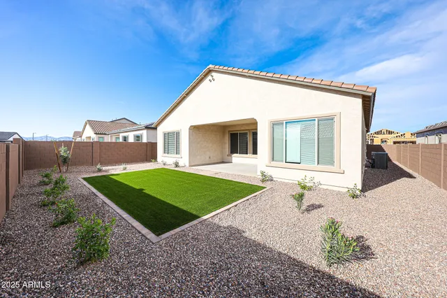 a view of a house with a yard and a garden