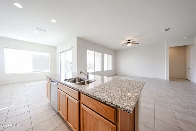 a kitchen with stainless steel appliances granite countertop a sink and a granite counter tops
