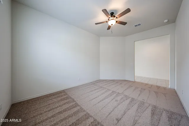 a view of a room with a ceiling fan