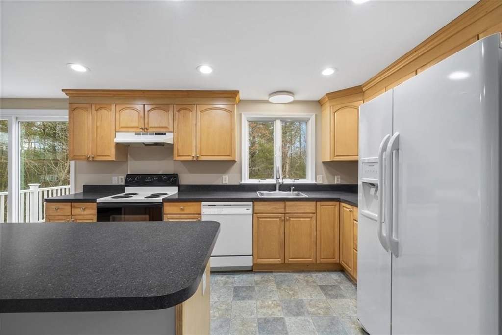 18 Heather Hill Road Bourne, MA 02532 - Photo 13 of 28 a kitchen with stainless steel appliances granite countertop a stove a sink a refrigerator and a refrigerator