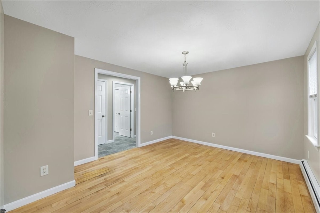18 Heather Hill Road Bourne, MA 02532 - Photo 16 of 28 wooden floor in an empty room with a window