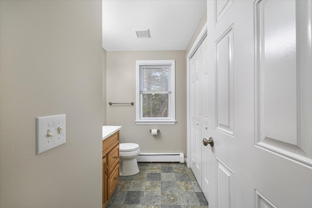 18 Heather Hill Road Bourne, MA 02532 - Photo 21 of 28 a bathroom with a toilet sink and mirror