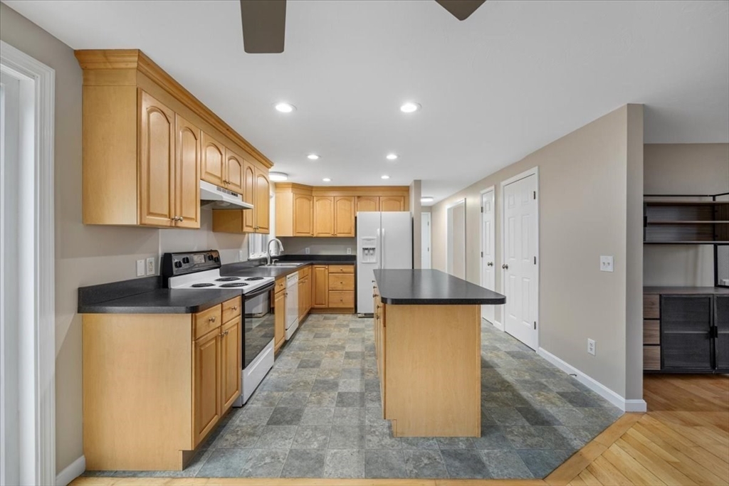 18 Heather Hill Road Bourne, MA 02532 - Photo 5 of 28 a kitchen with stainless steel appliances granite countertop a stove a sink and a refrigerator