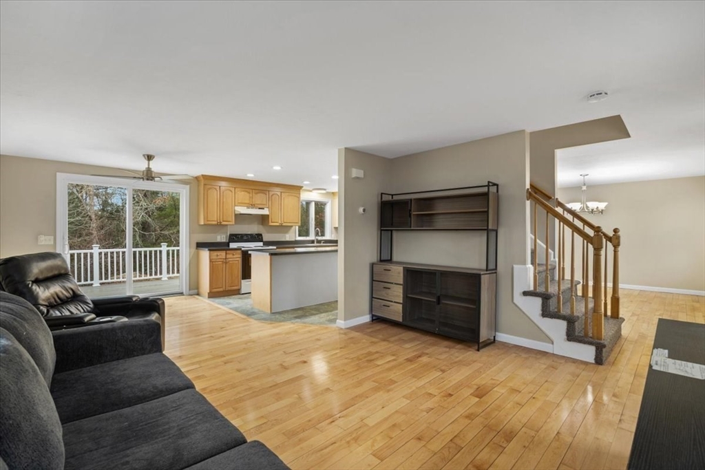 18 Heather Hill Road Bourne, MA 02532 - Photo 10 of 28 a living room with furniture cabinets and a kitchen