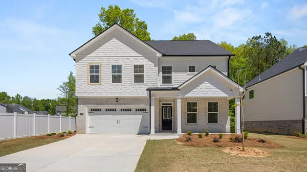 a front view of a house with a yard