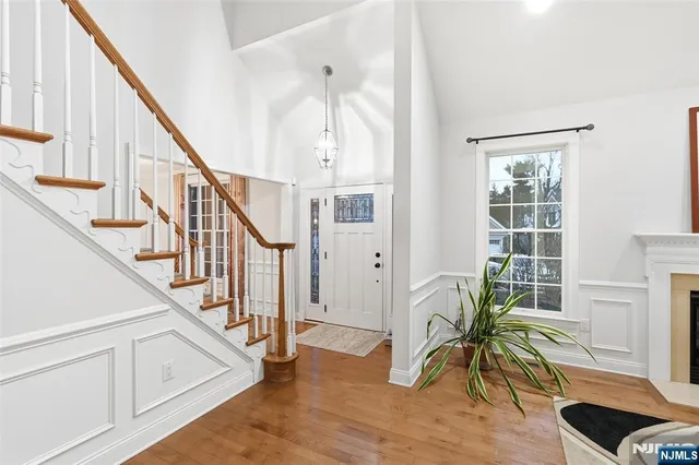 a view of entryway with wooden floor and windows