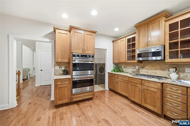 a kitchen with stainless steel appliances a stove top oven and cabinets