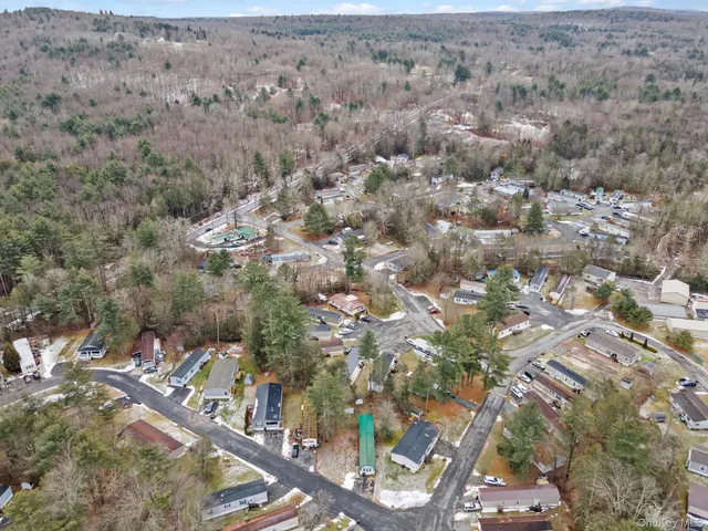 an aerial view of house with yard and mountain view