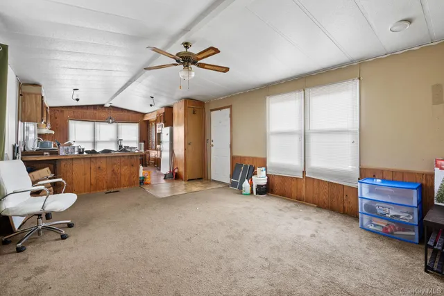 a view of a livingroom with furniture and a window