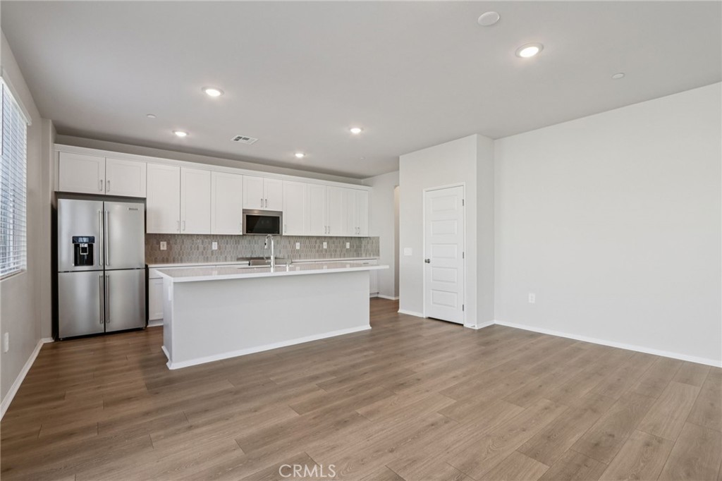 2070 Meyer Lane Redlands, CA 92374 - Photo 12 of 44 a view of kitchen with granite countertop refrigerator oven sink and white cabinets