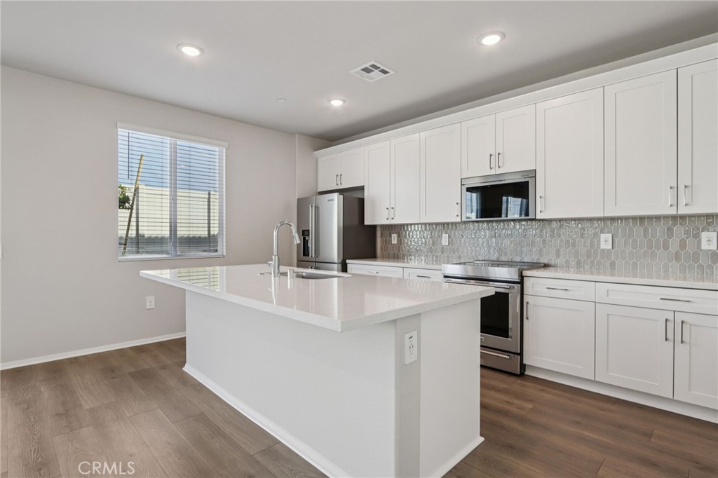 2070 Meyer Lane Redlands, CA 92374 - Photo 14 of 44 a kitchen with stainless steel appliances granite countertop a sink stove and refrigerator