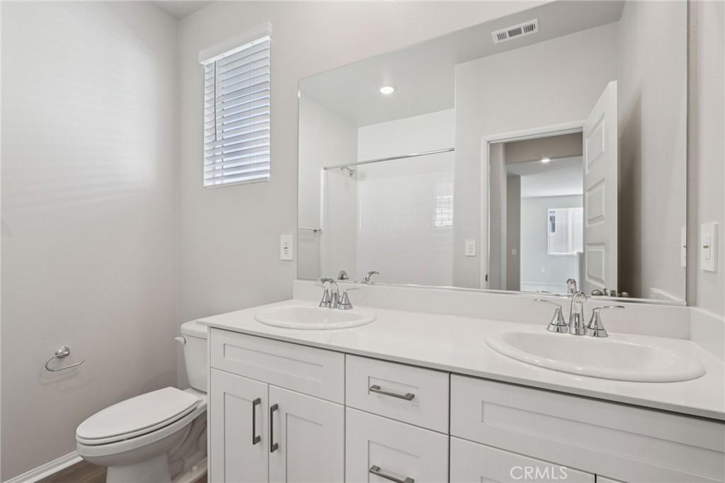 2070 Meyer Lane Redlands, CA 92374 - Photo 28 of 44 a bathroom with a sink a toilet and mirror