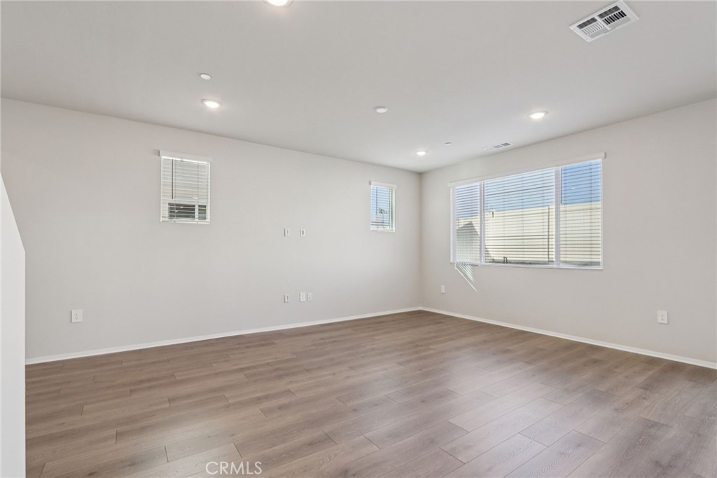 2070 Meyer Lane Redlands, CA 92374 - Photo 6 of 44 a view of an empty room with wooden floor and a window