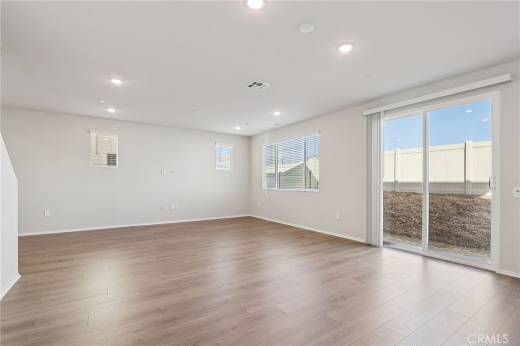 2070 Meyer Lane Redlands, CA 92374 - Photo 9 of 44 an empty room with wooden floor and windows