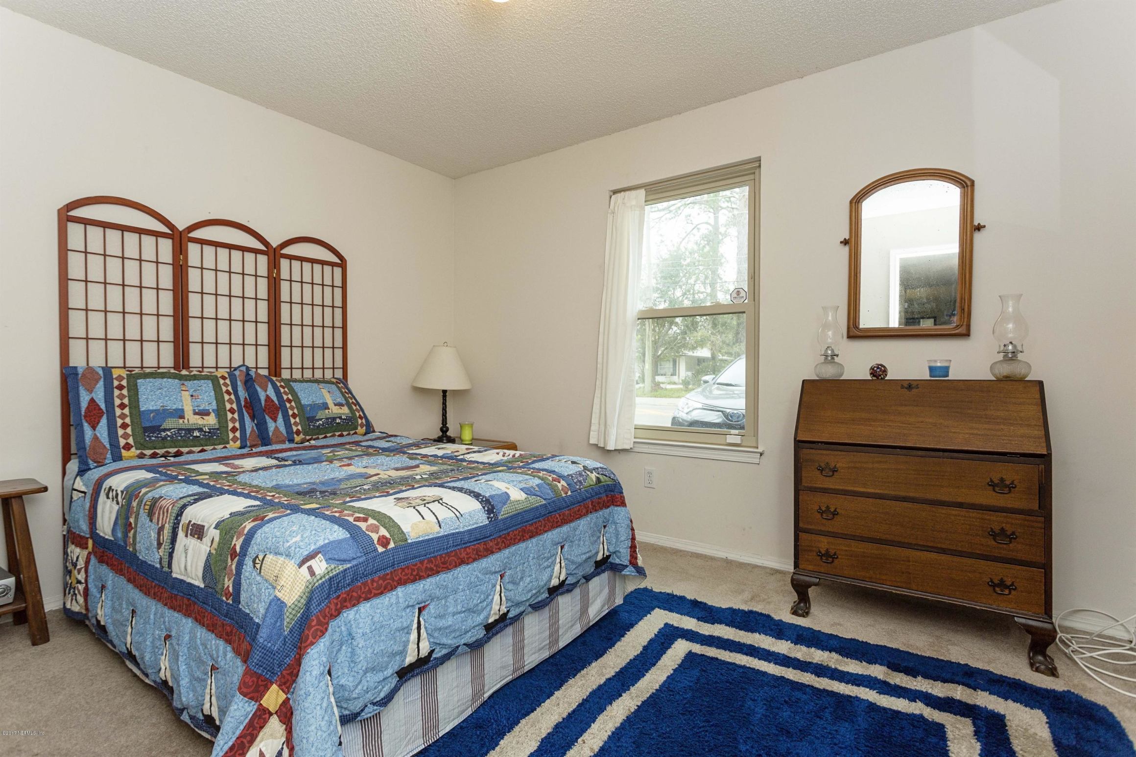 4775 Barnes Road South Jacksonville, FL 32207 - Photo 12 of 19 a bedroom with a bed and a dresser