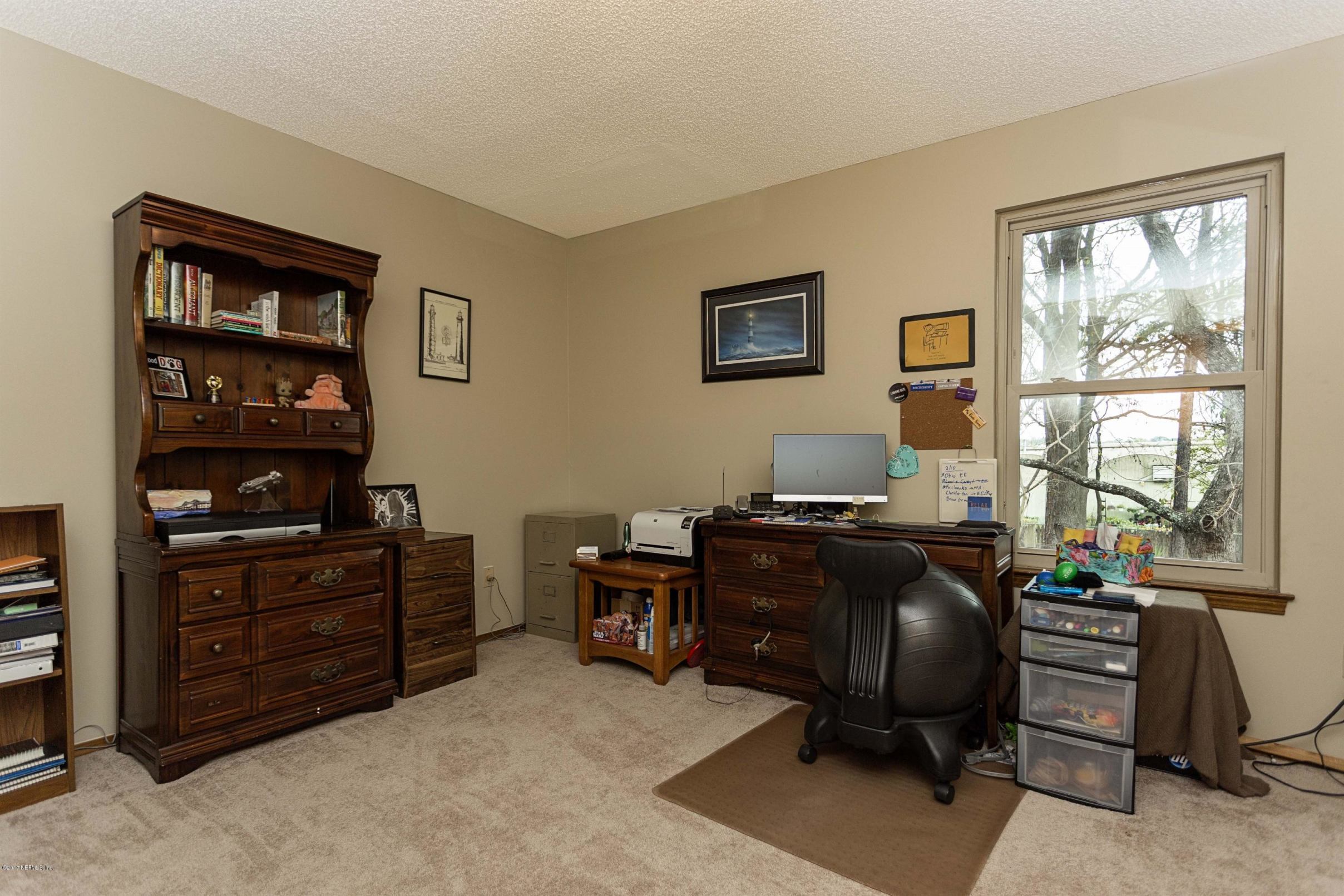 4775 Barnes Road South Jacksonville, FL 32207 - Photo 14 of 19 a view of a workspace with furniture and a window