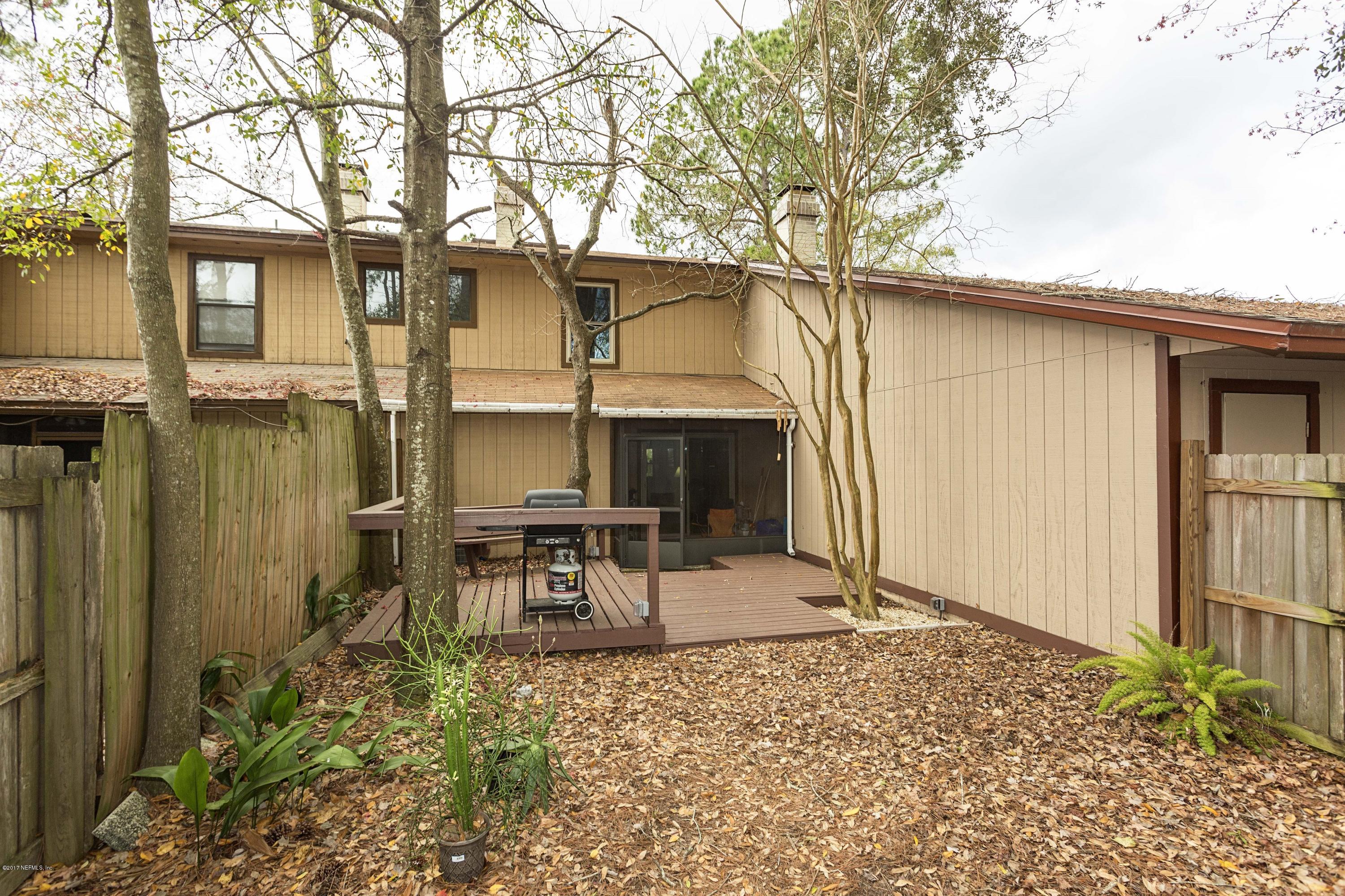 4775 Barnes Road South Jacksonville, FL 32207 - Photo 17 of 19 a backyard of a house with table and chairs