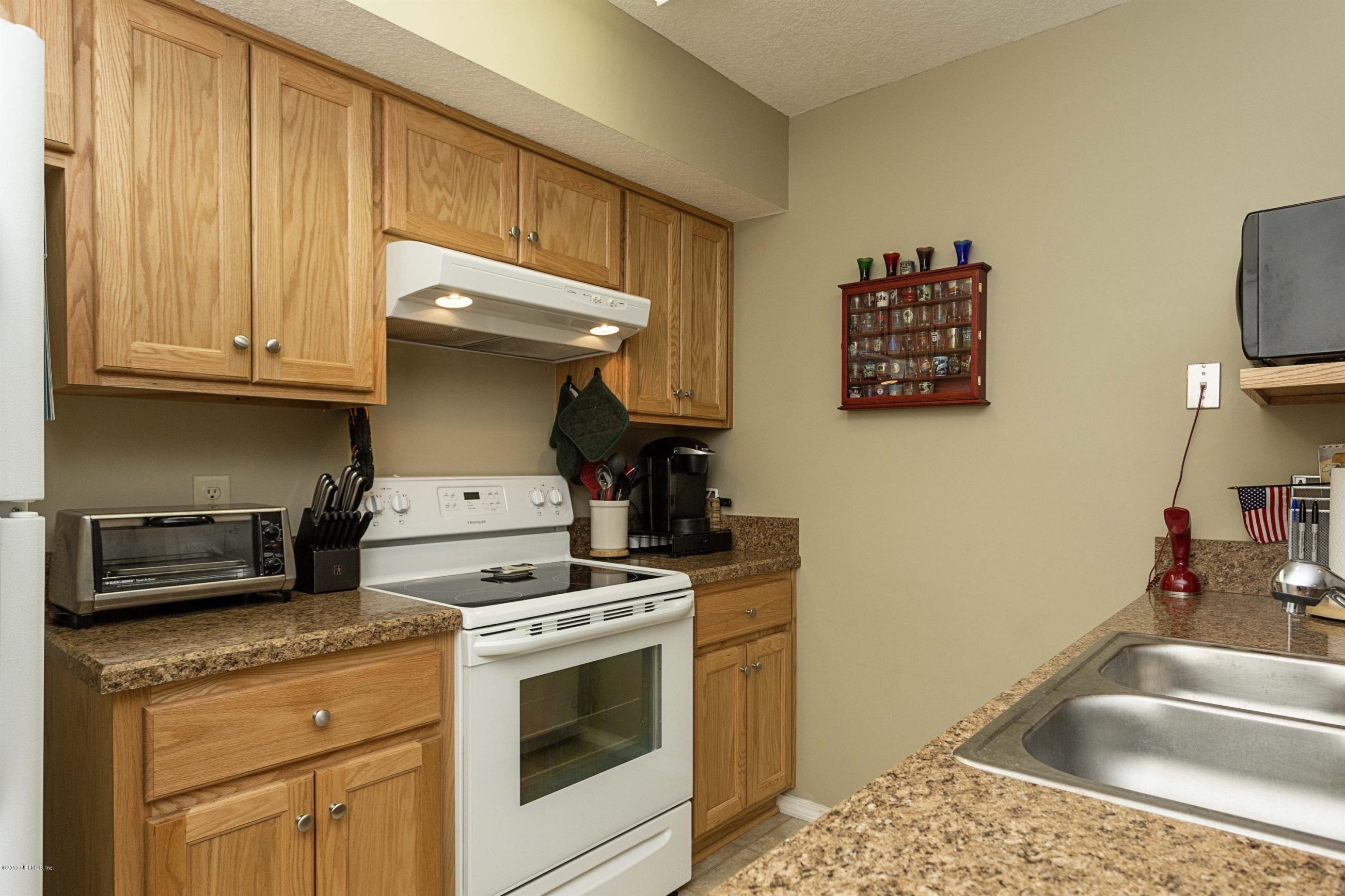 4775 Barnes Road South Jacksonville, FL 32207 - Photo 8 of 19 a kitchen with stainless steel appliances granite countertop a sink stove and cabinets