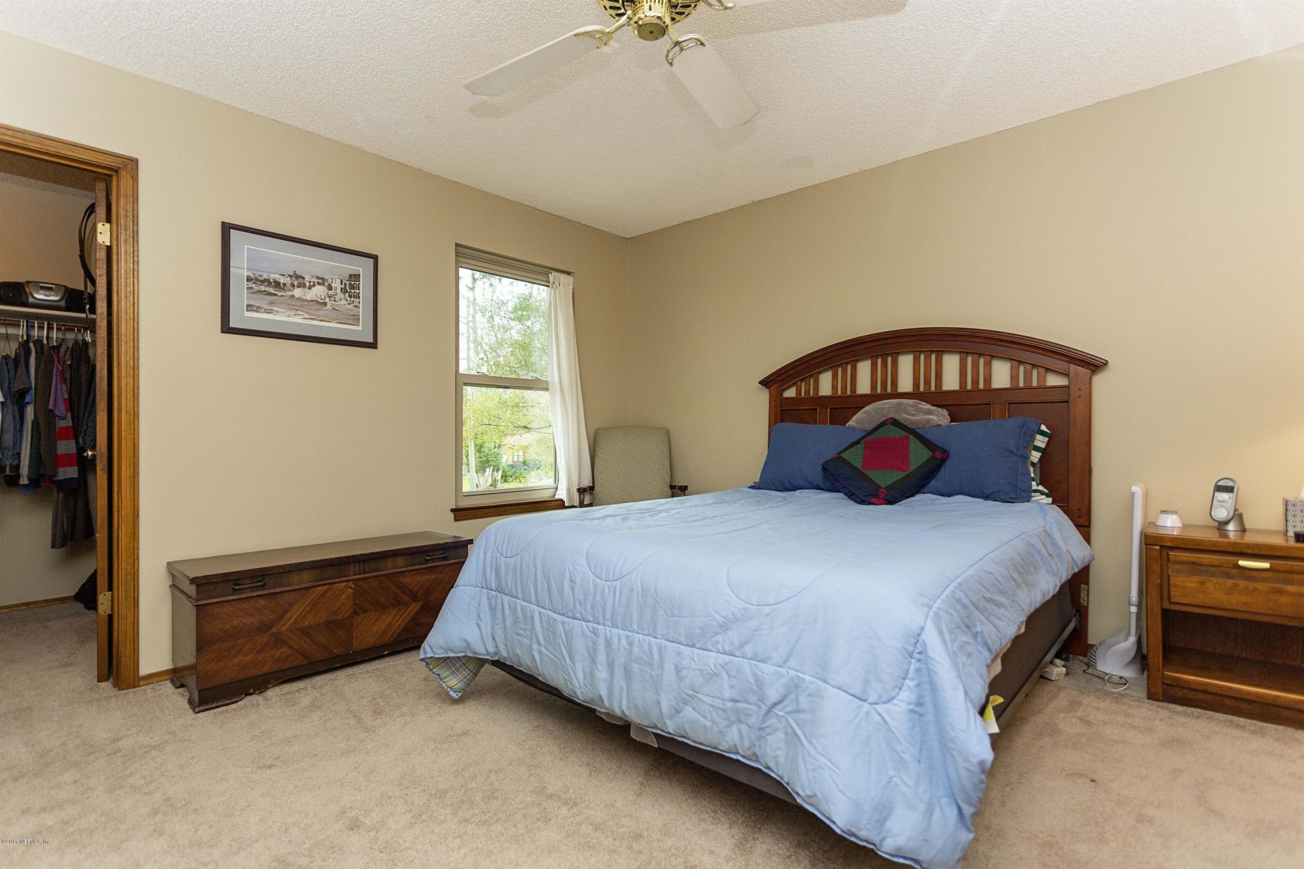 4775 Barnes Road South Jacksonville, FL 32207 - Photo 10 of 19 a bedroom with a bed and a chandelier
