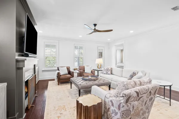 a living room with fireplace furniture and a flat screen tv
