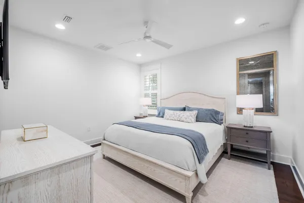 a bedroom with a bed and a lamp