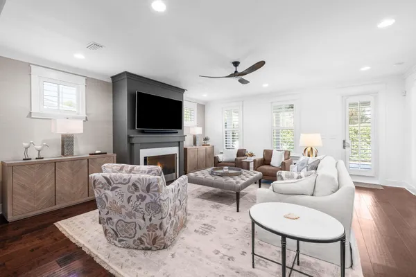 a living room with furniture a flat screen tv and a window