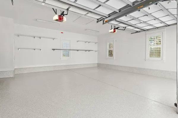 a view of a white house with swimming pool and sitting area