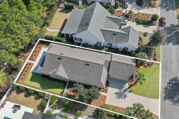 an aerial view of a house with a yard and lake view