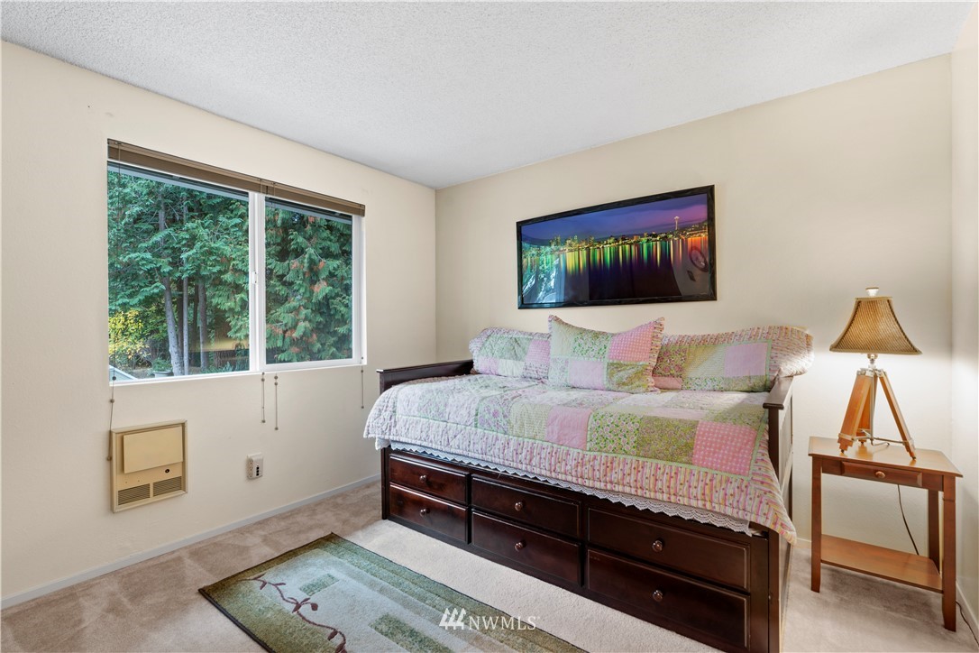 20915 West Richmond Road Bothell, WA 98021 - Photo 14 of 26 a bedroom with a bed and a night stand