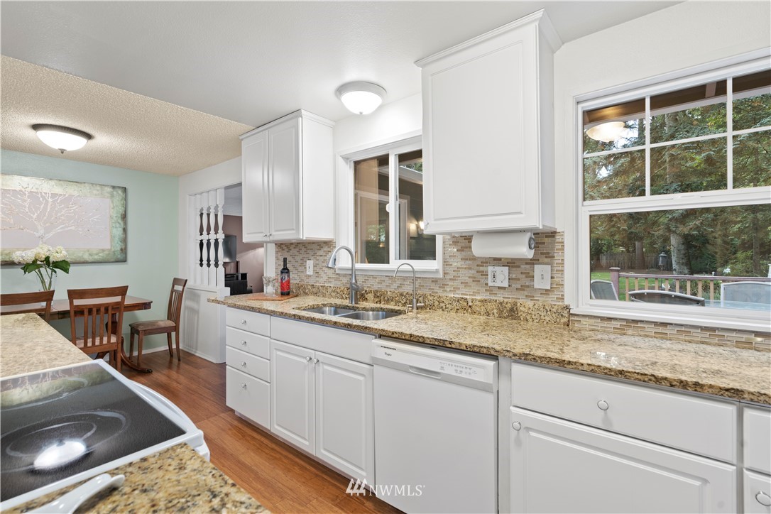 20915 West Richmond Road Bothell, WA 98021 - Photo 5 of 26 a kitchen with a sink stove and cabinets