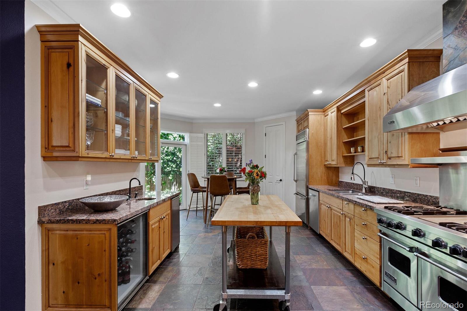 167 Monroe Street Denver, CO 80206 - Photo 13 of 39 a kitchen with stainless steel appliances granite countertop a stove and a sink
