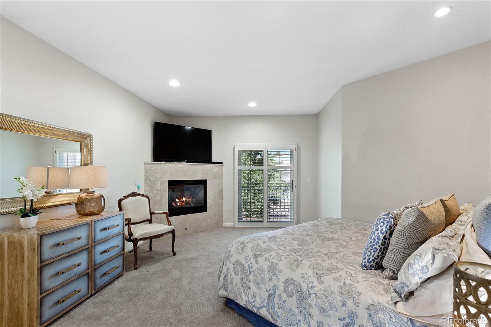 167 Monroe Street Denver, CO 80206 - Photo 16 of 39 a spacious bedroom with a bed and a fireplace