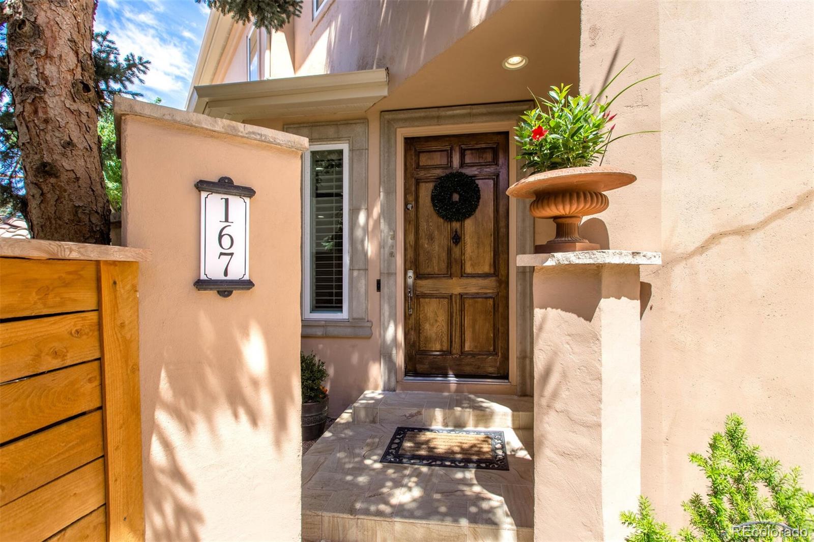 167 Monroe Street Denver, CO 80206 - Photo 2 of 39 a front view of a house with a yard