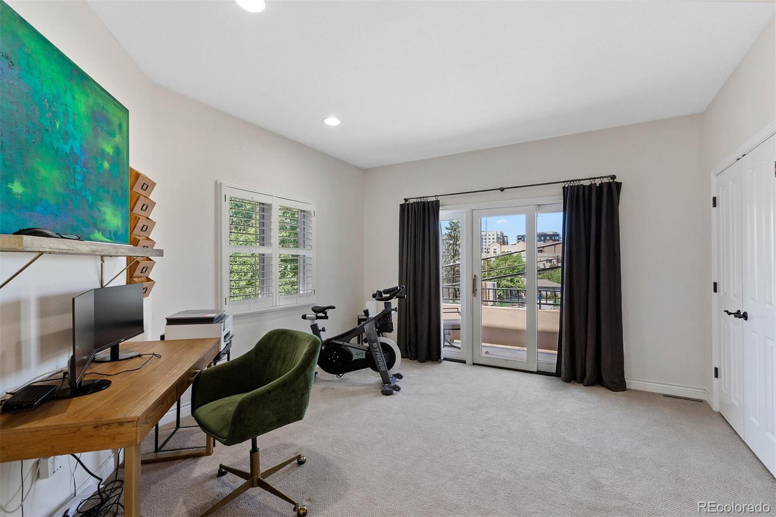 167 Monroe Street Denver, CO 80206 - Photo 21 of 39 a living room with furniture and a flat screen tv