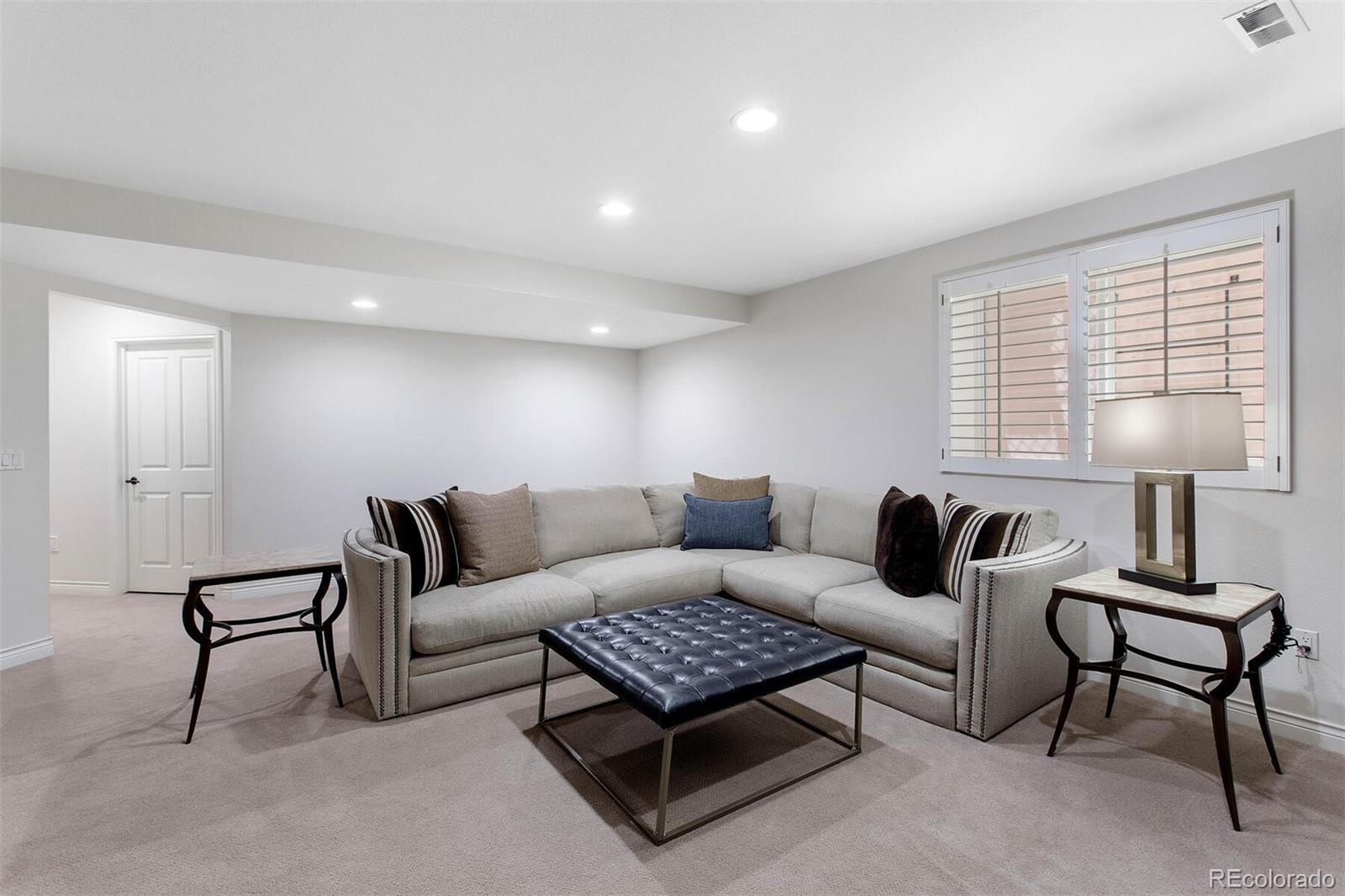 167 Monroe Street Denver, CO 80206 - Photo 26 of 39 a living room with furniture and a lamp