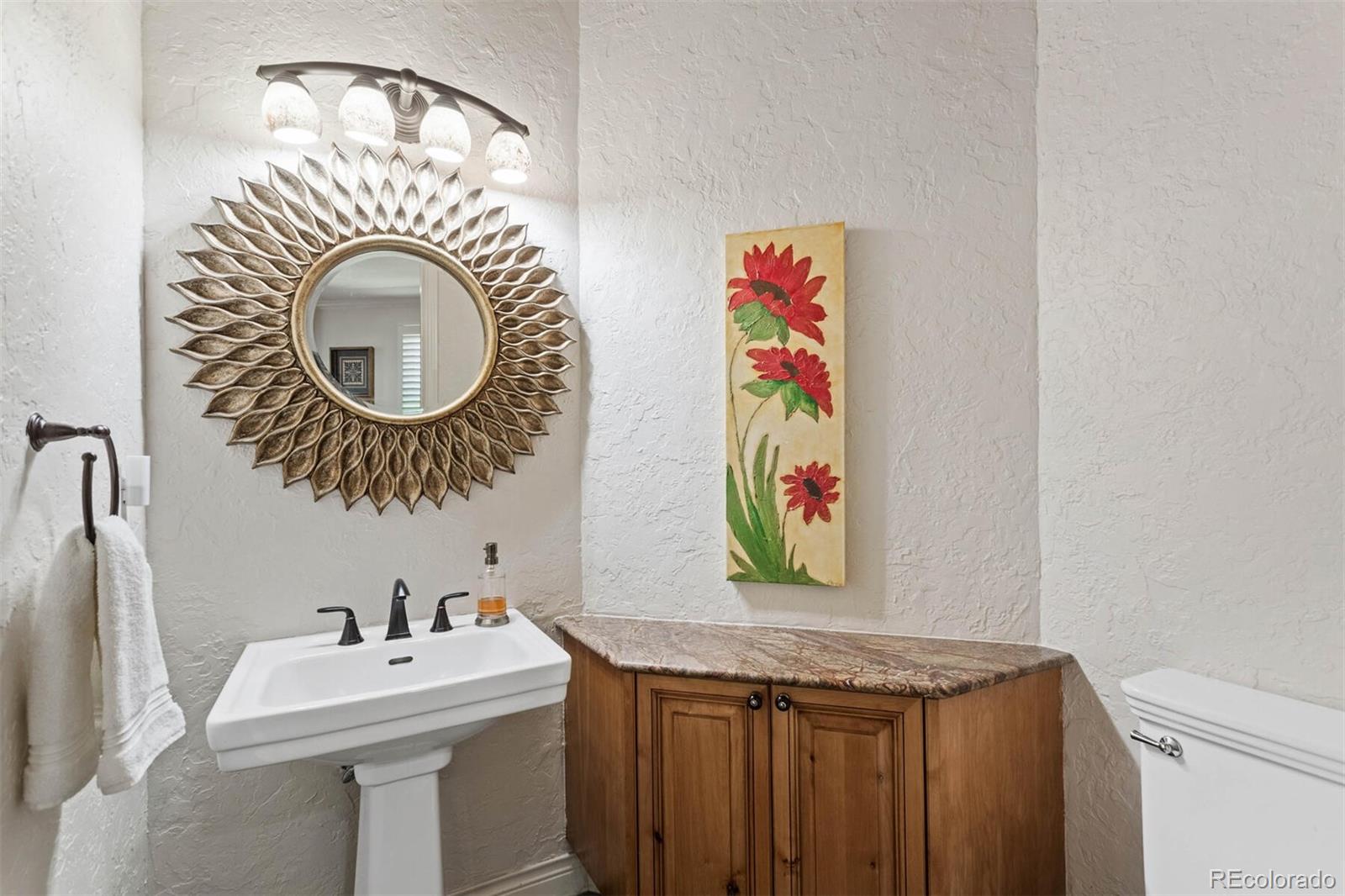 167 Monroe Street Denver, CO 80206 - Photo 30 of 39 a bathroom with a sink and a mirror