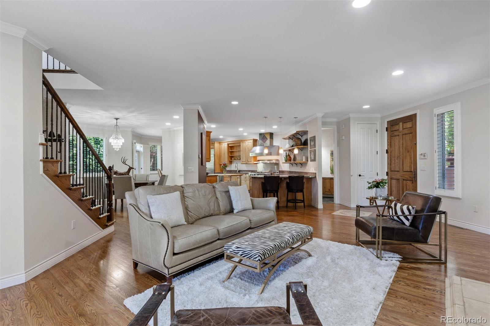 167 Monroe Street Denver, CO 80206 - Photo 7 of 39 a living room with furniture kitchen view and a wooden floor