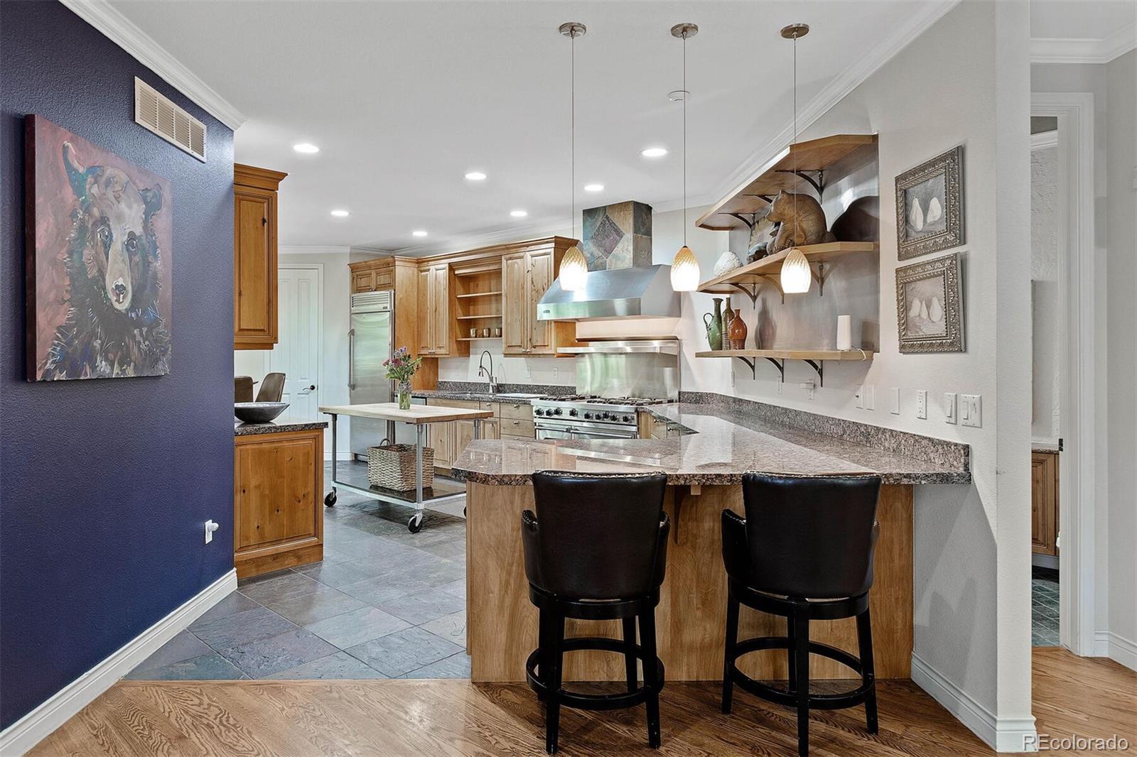 167 Monroe Street Denver, CO 80206 - Photo 8 of 39 a kitchen with cabinets and chairs in it