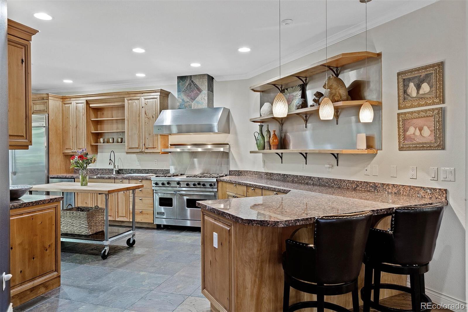 167 Monroe Street Denver, CO 80206 - Photo 9 of 39 a kitchen with a table chairs stove and cabinets